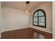 Dining room featuring hardwood floors, contemporary lighting fixture, and an arched window at 1831 Cardamon Dr, Trinity, FL 34655