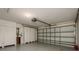 A spacious garage with bright white walls, ample storage cabinets, and a working garage door at 1831 Cardamon Dr, Trinity, FL 34655