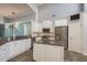 Bright kitchen features white cabinets, stainless steel appliances, granite countertops, and a stylish backsplash at 1831 Cardamon Dr, Trinity, FL 34655