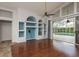 Open living room with custom built-ins, hardwood floors, and pool views through sliding glass doors at 1831 Cardamon Dr, Trinity, FL 34655