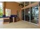 An outdoor kitchen and patio with tiled counter, stainless steel sink, and large sliding glass doors to the home at 1831 Cardamon Dr, Trinity, FL 34655
