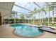 Enjoy a large, screened in private pool and spa surrounded by lush landscaping and tall palm trees at 1831 Cardamon Dr, Trinity, FL 34655
