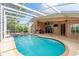 A beautiful in-ground pool is screened-in and has views of the home's lanai and back yard at 1831 Cardamon Dr, Trinity, FL 34655