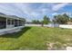 Well-maintained backyard featuring a storage shed, lush lawn, and a white privacy fence at 2027 Fentress Ct, Spring Hill, FL 34609