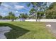 Large backyard features lush lawn, mature trees, storage shed, and a white privacy fence at 2027 Fentress Ct, Spring Hill, FL 34609