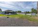 Spacious backyard with a screened porch, large shed, playset and white privacy fence at 2027 Fentress Ct, Spring Hill, FL 34609