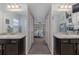 Bathroom featuring dual vanities, granite countertops, and a view into the Primary bedroom at 2027 Fentress Ct, Spring Hill, FL 34609
