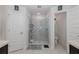 Bright bathroom showcasing a glass-enclosed shower, tile flooring, and a separate toilet room at 2027 Fentress Ct, Spring Hill, FL 34609