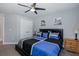 Comfortable bedroom featuring a large bed with colorful bedding, closet space, and carpet floors at 2027 Fentress Ct, Spring Hill, FL 34609