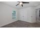 Well-lit bedroom featuring carpet flooring, a ceiling fan, and a spacious closet with a connecting room at 2027 Fentress Ct, Spring Hill, FL 34609