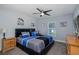 Well lit bedroom featuring carpet floors, ceiling fan, and a large bed with nightstands at 2027 Fentress Ct, Spring Hill, FL 34609