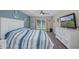 Bright bedroom featuring a white dresser, large window, and nautical decor creating a relaxing atmosphere at 2027 Fentress Ct, Spring Hill, FL 34609