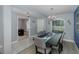 Bright dining room with gray walls, gray chairs, and a dark wood table with blue accents at 2027 Fentress Ct, Spring Hill, FL 34609