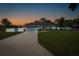 Charming home exterior with a long driveway, well-manicured lawn and beautiful landscaping at 2027 Fentress Ct, Spring Hill, FL 34609
