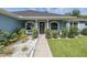 Cozy porch with seating, decorative wreath, and vibrant blue exterior at 2027 Fentress Ct, Spring Hill, FL 34609