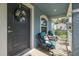 A cozy front porch with seating, a decorative wreath, and a vibrant blue exterior at 2027 Fentress Ct, Spring Hill, FL 34609