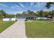 Charming one-story home featuring a well-manicured lawn, concrete driveway, and stylish light blue exterior at 2027 Fentress Ct, Spring Hill, FL 34609