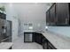 This is a spacious kitchen featuring granite countertops, stainless steel appliances, and dark cabinets at 2027 Fentress Ct, Spring Hill, FL 34609