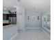 Spacious kitchen with stainless steel appliances, including a refrigerator and a pantry, and a bright dining area at 2027 Fentress Ct, Spring Hill, FL 34609