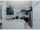 Open kitchen with stainless steel appliances, granite countertops, and view of dining area at 2027 Fentress Ct, Spring Hill, FL 34609