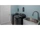 Laundry room featuring a black washer and dryer set with a sink and decorations at 2027 Fentress Ct, Spring Hill, FL 34609