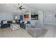 Open-concept living area with blue sofas, view of kitchen, and lots of natural light at 2027 Fentress Ct, Spring Hill, FL 34609