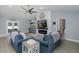 Spacious living room featuring a modern fireplace, TV, built-ins, and comfortable seating at 2027 Fentress Ct, Spring Hill, FL 34609