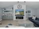 Cozy living room with electric fireplace, built-ins, and blue couches at 2027 Fentress Ct, Spring Hill, FL 34609