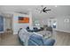 Inviting living room with comfortable blue sofa, gray recliner, and bright natural light at 2027 Fentress Ct, Spring Hill, FL 34609