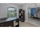 Bright office space with a large window, wood floors, and view into the dining area at 2027 Fentress Ct, Spring Hill, FL 34609
