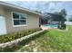 Backyard featuring block retaining wall and a screened-in pool area at 3128 Montague Ave, Spring Hill, FL 34608