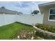 Fenced in backyard with side gate access and a grassy area at 3128 Montague Ave, Spring Hill, FL 34608