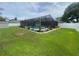 Large backyard featuring pool with a screen, a shed and privacy fence at 3128 Montague Ave, Spring Hill, FL 34608