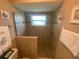 Modern bathroom with a glass-enclosed shower, tiled walls, and neutral decor at 3128 Montague Ave, Spring Hill, FL 34608