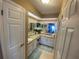 Bathroom with dual vanities, granite countertops, a large mirror, and well-lit with neutral tones at 3128 Montague Ave, Spring Hill, FL 34608
