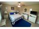 Cozy bedroom with white wicker furniture and a ceiling fan for comfortable living at 3128 Montague Ave, Spring Hill, FL 34608