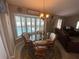 Bright dining area with a round table, wicker chairs and lots of natural light at 3128 Montague Ave, Spring Hill, FL 34608