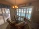Cozy dining area features a bay window overlooking the pool and a stylish chandelier at 3128 Montague Ave, Spring Hill, FL 34608