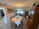 Open-concept dining area with wood table set with room for six guests and a large china cabinet at 3128 Montague Ave, Spring Hill, FL 34608