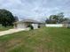Charming single-story home featuring an attached garage, lush lawn, and a white vinyl fence for added privacy at 3128 Montague Ave, Spring Hill, FL 34608