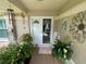 The cozy front porch welcomes you with a double door entry and decorative plants at 3128 Montague Ave, Spring Hill, FL 34608