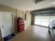 This garage features painted flooring, a tool chest, and an automatic garage door at 3128 Montague Ave, Spring Hill, FL 34608
