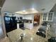 Bright kitchen featuring granite countertops and modern appliances with a breakfast nook in view at 3128 Montague Ave, Spring Hill, FL 34608