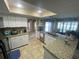 Bright kitchen with granite countertops and views of the dining room at 3128 Montague Ave, Spring Hill, FL 34608