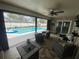 This lanai is the perfect spot with comfy seating and a gorgeous pool view at 3128 Montague Ave, Spring Hill, FL 34608