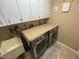 Laundry room features a laundry sink, cabinets, and washer and dryer at 3128 Montague Ave, Spring Hill, FL 34608