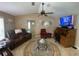 Cozy living room with comfy seating, a desk, and a ceiling fan at 3128 Montague Ave, Spring Hill, FL 34608