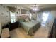 Bright bedroom with a plush bed, decorative wall art and access to a covered patio at 3128 Montague Ave, Spring Hill, FL 34608