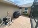 Enclosed patio with brick pavers, grill, storage unit, and adjacent pool screening at 3128 Montague Ave, Spring Hill, FL 34608