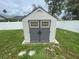 Backyard storage shed with double doors and transom windows at 3128 Montague Ave, Spring Hill, FL 34608